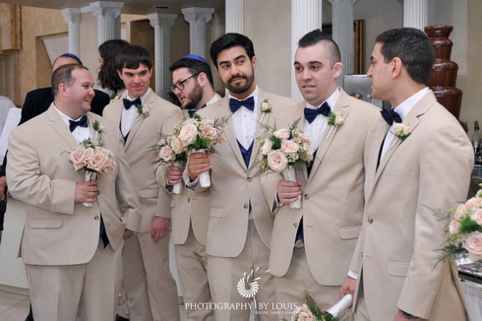 groomsmen holding bouquets
