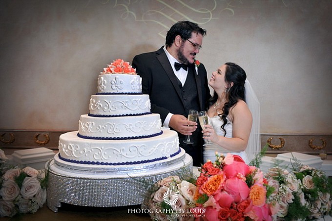 bride & groom behind cake